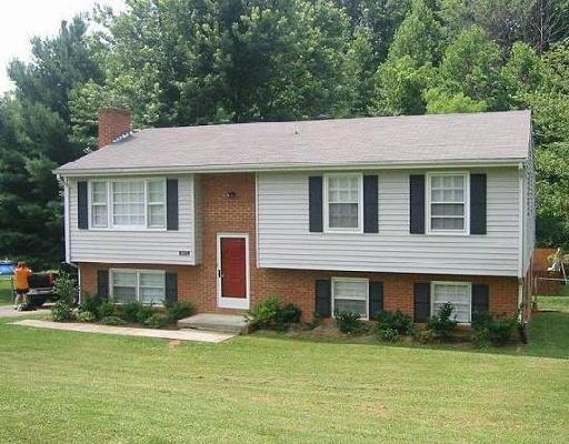 955 Mountain Pass Road Blue Ridge, VA 24064 - Photo 1 of 5 a front view of a house with a garden and trees