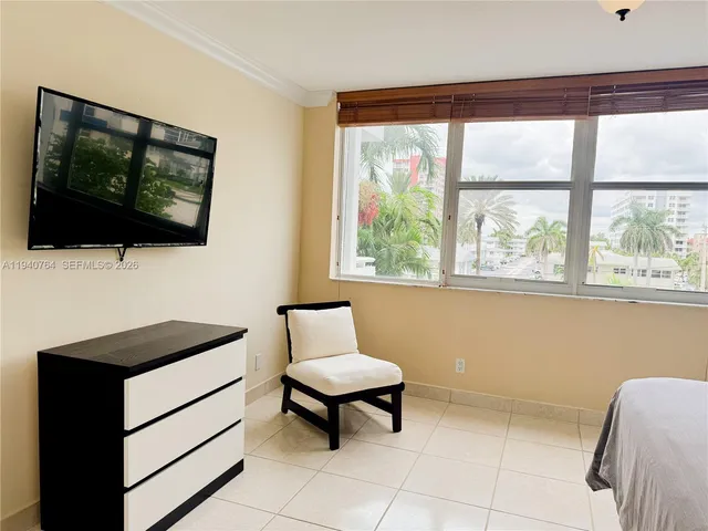 a living room with a flat screen tv and a window