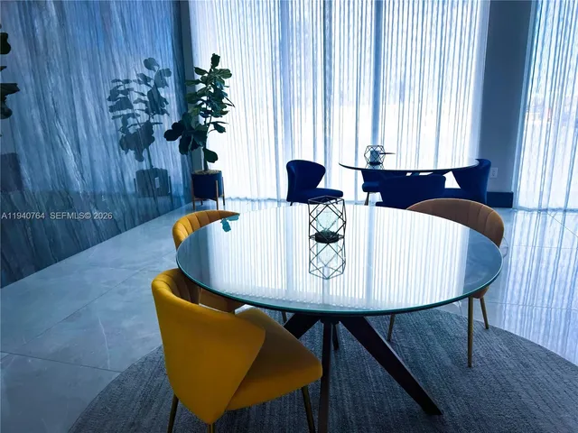 a dining room with furniture and wooden floor