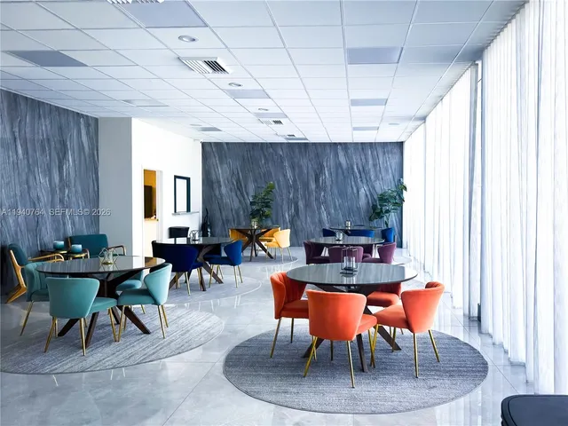 a dining room with furniture and a window