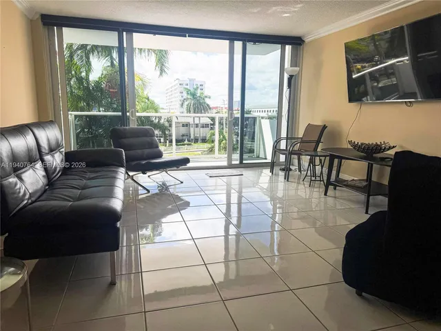 a living room with furniture and a floor to ceiling window