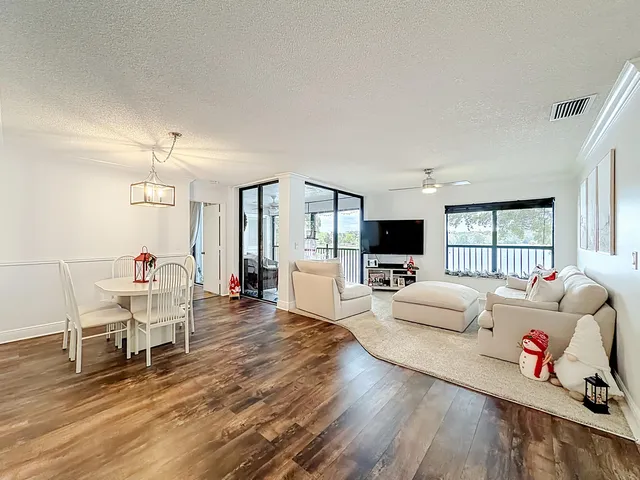 a view of a dining room with furniture wooden floor and chandelier