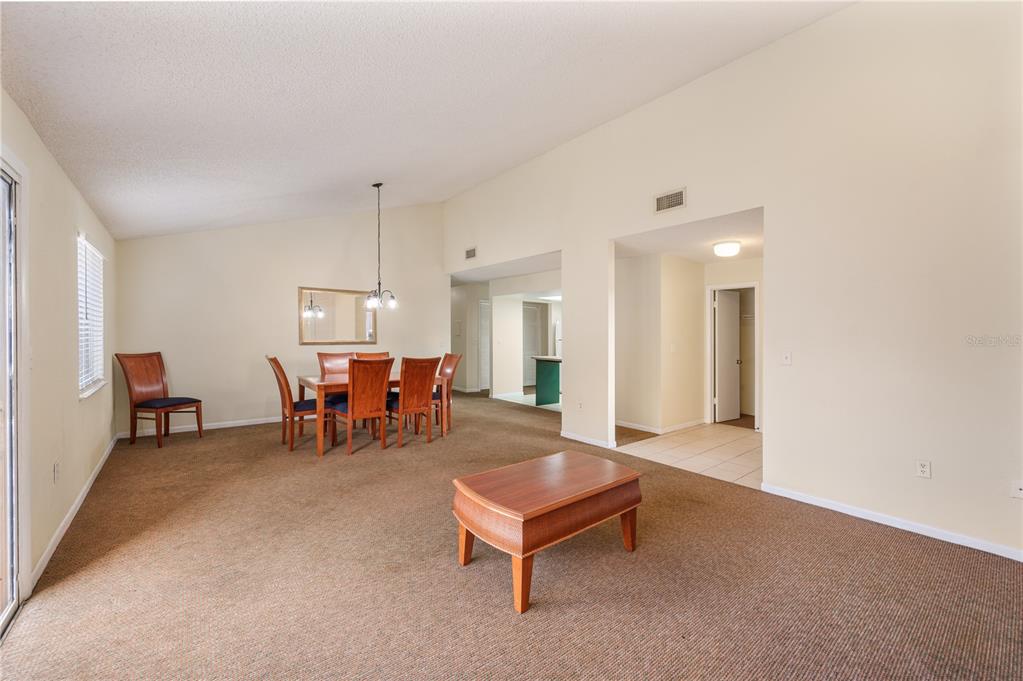4231 Oak Loop, Unit 51 Mulberry, FL 33860 - Photo 11 of 29 a living room with furniture and a table
