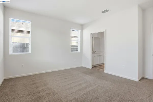 an empty room with windows and closet