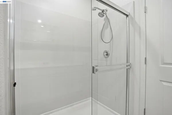 a bathroom with a glass shower door