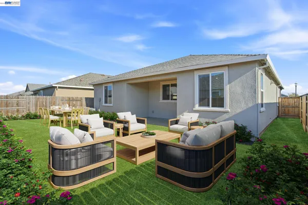 a backyard of a house with yard fountain and outdoor seating