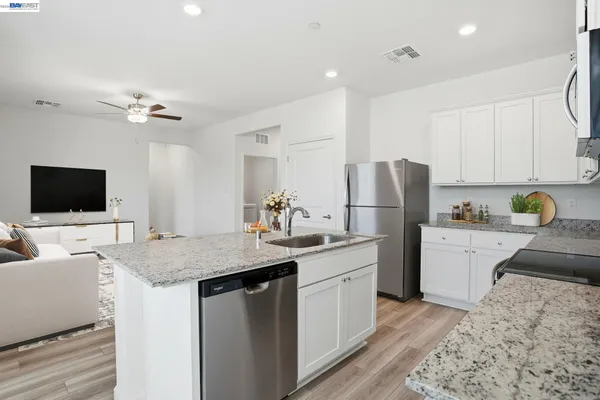a kitchen with a sink refrigerator and microwave