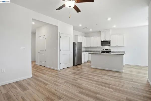 a view of kitchen with refrigerator microwave and stove