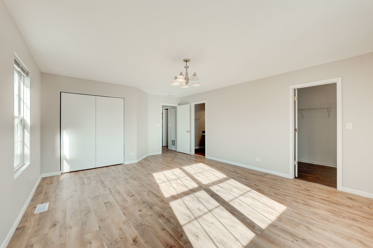277 Springbrook Trail South Oswego, IL 60543 - Photo 14 of 28 a view of a room with wooden floor and a ceiling fan