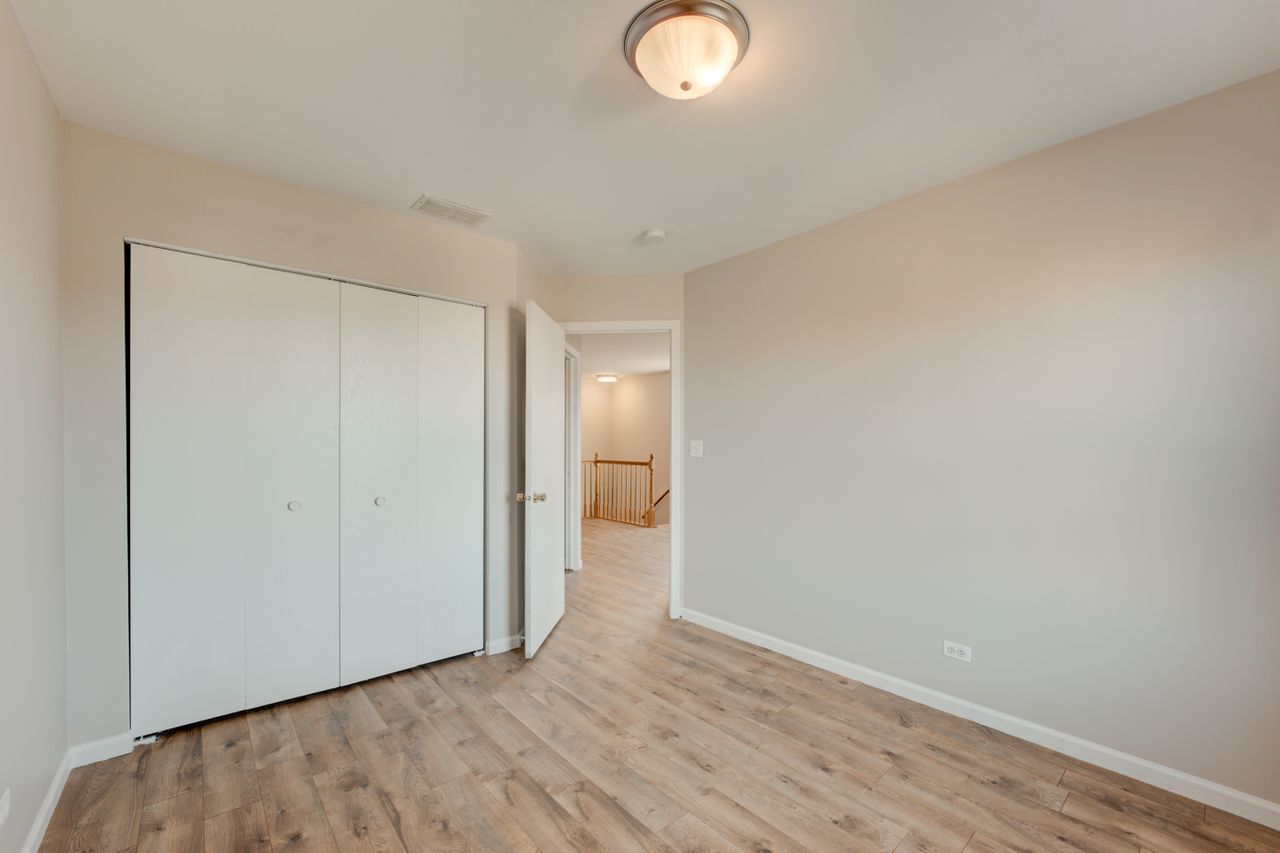 277 Springbrook Trail South Oswego, IL 60543 - Photo 16 of 28 a view of an empty room with wooden floor