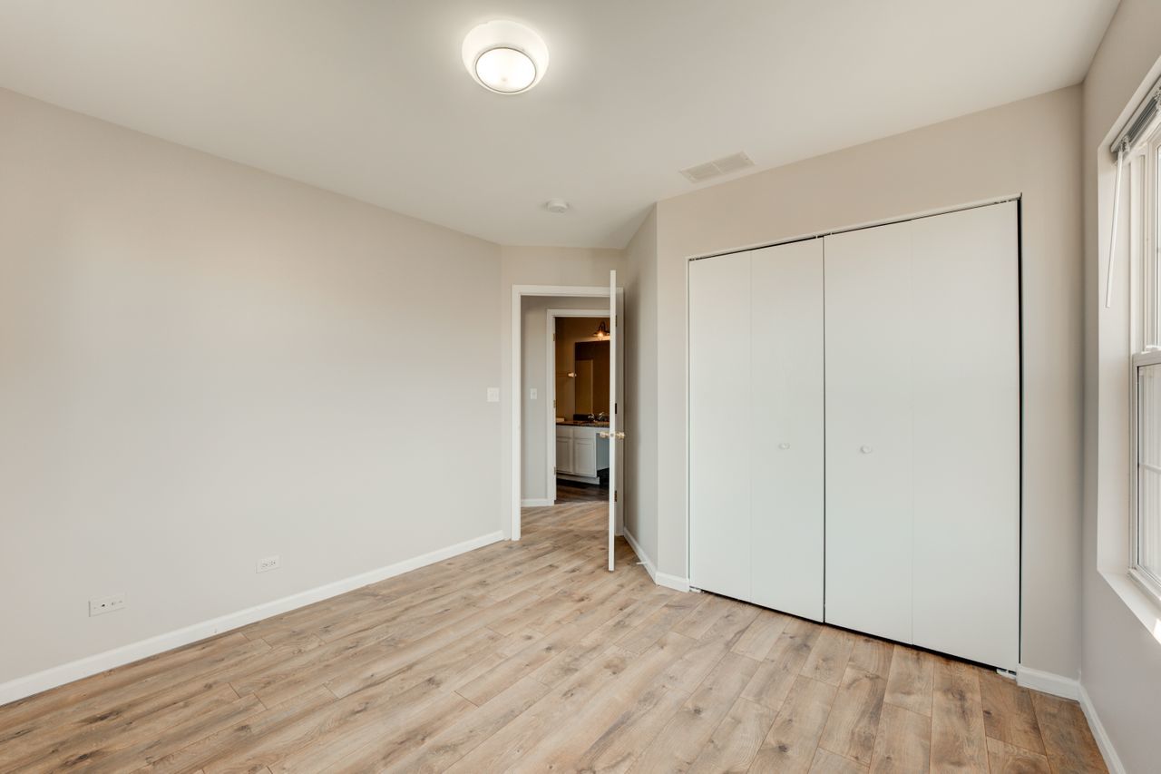 277 Springbrook Trail South Oswego, IL 60543 - Photo 21 of 28 a view of an empty room with wooden floor