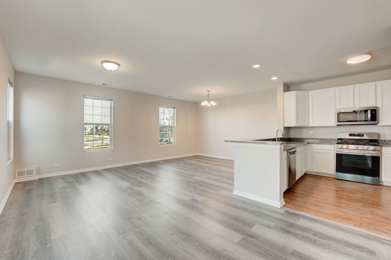 277 Springbrook Trail South Oswego, IL 60543 - Photo 23 of 28 a view of kitchen with wooden floor and electronic appliances