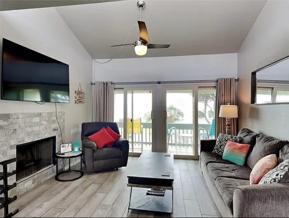 a living room with furniture a fireplace and a flat screen tv