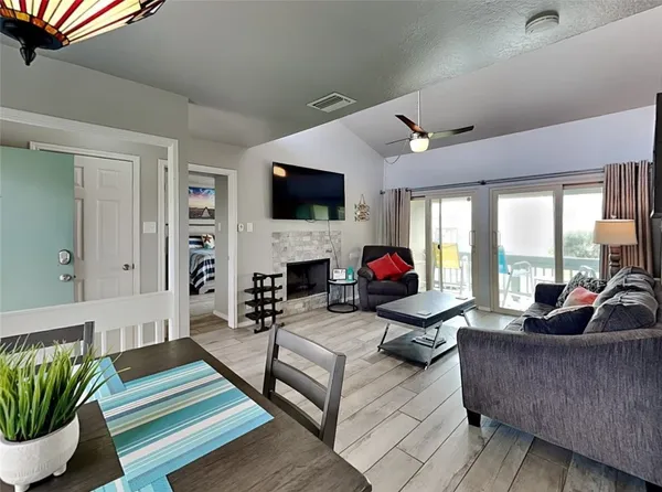 a living room with furniture fireplace and a flat screen tv