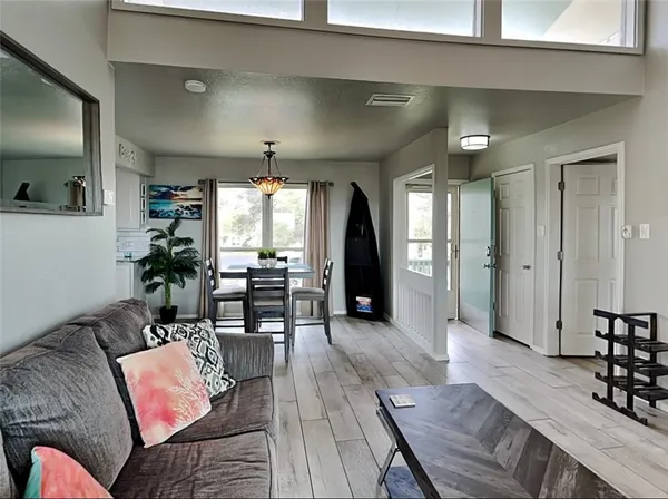 a living room with furniture and wooden floor