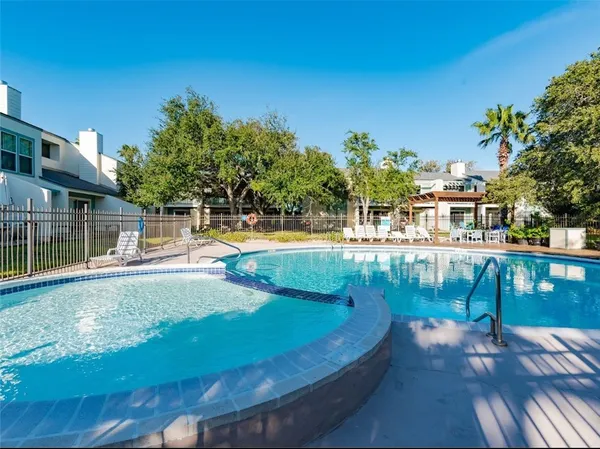 a view of a swimming pool with a patio
