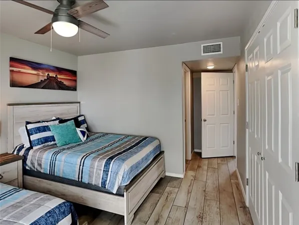 a bedroom with a bed and wooden floor