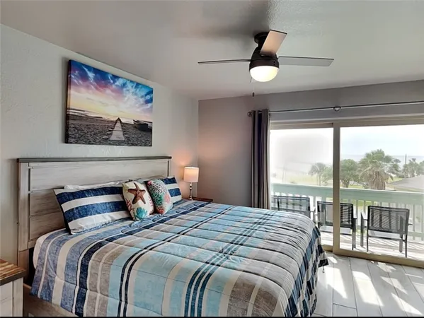 a bedroom with a large bed and a painting on the wall