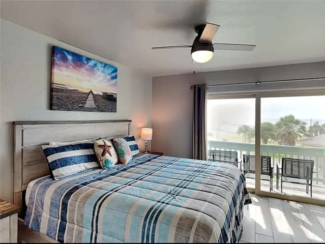 a bedroom with a large bed and a painting on the wall