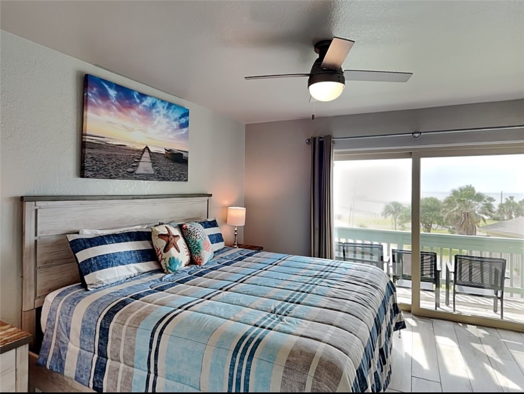 2003 North Fulton Beach Road, Unit 14 Rockport, TX 78382 - Photo 6 of 30 a bedroom with a large bed and a painting on the wall