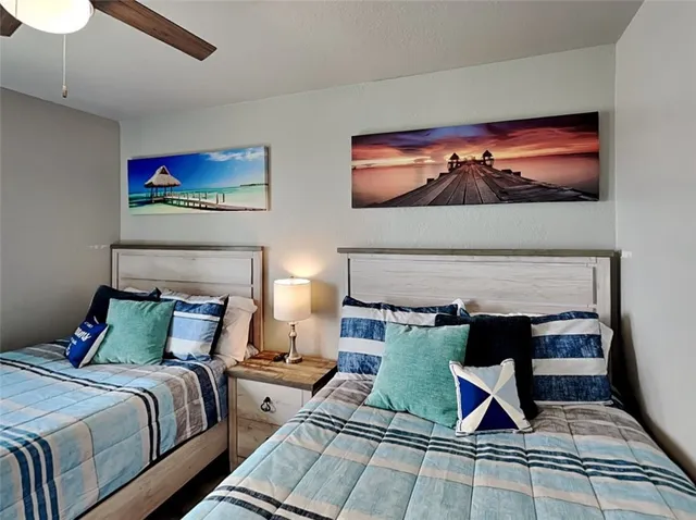 a bedroom with furniture and a painting on the wall