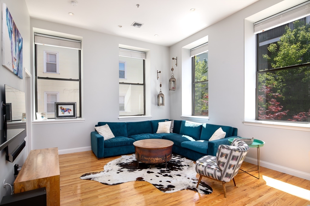 11 Wyman Street, Unit 2B Boston, MA 02130 - Photo 2 of 11 a living room with furniture and a large window