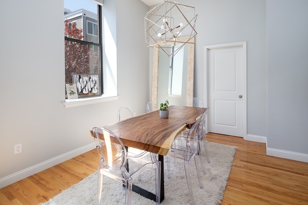 11 Wyman Street, Unit 2B Boston, MA 02130 - Photo 5 of 11 a view of a dining room with furniture and a chandelier