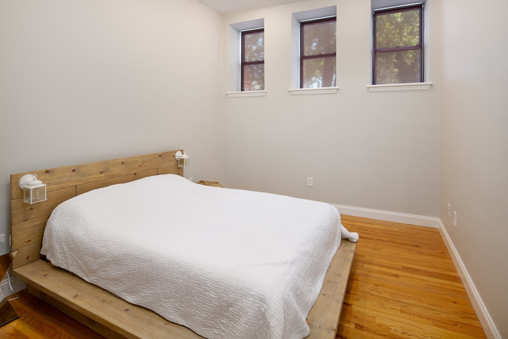 11 Wyman Street, Unit 2B Boston, MA 02130 - Photo 7 of 11 a bed sitting in a bedroom next to a window