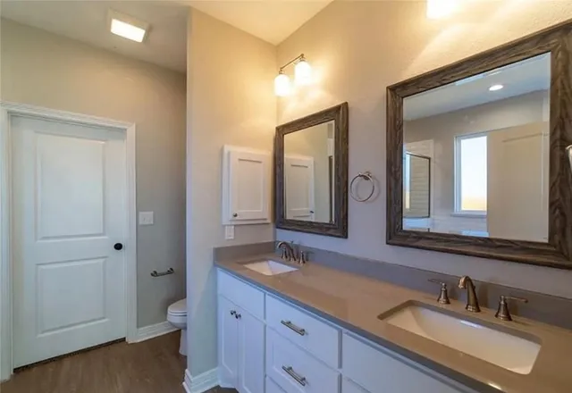 a bathroom with a sink double vanity and a mirror