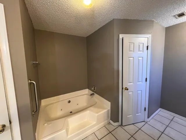 a bathroom with a bathtub and toilet