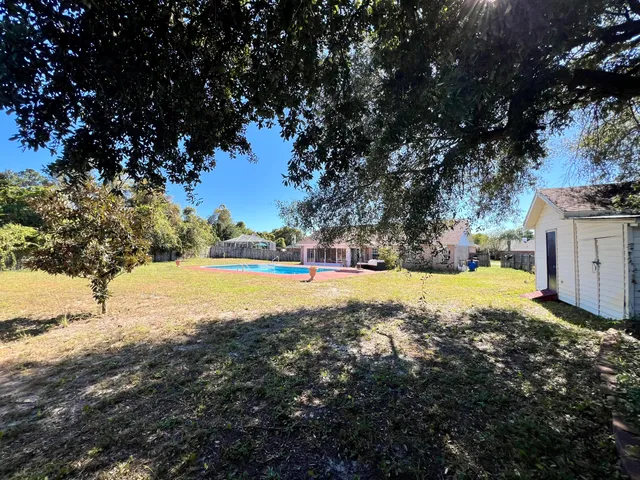 a view of yard with swimming pool outdoor space and trees