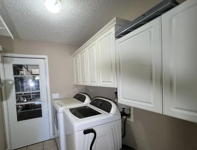 a kitchen with a refrigerator and a stove top oven