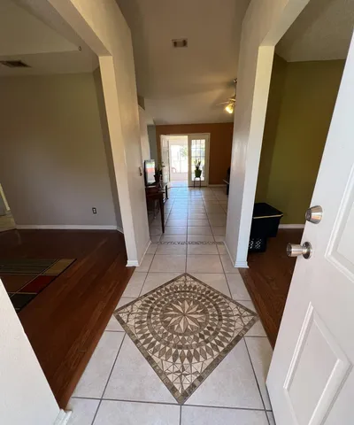 an entryway with a rug
