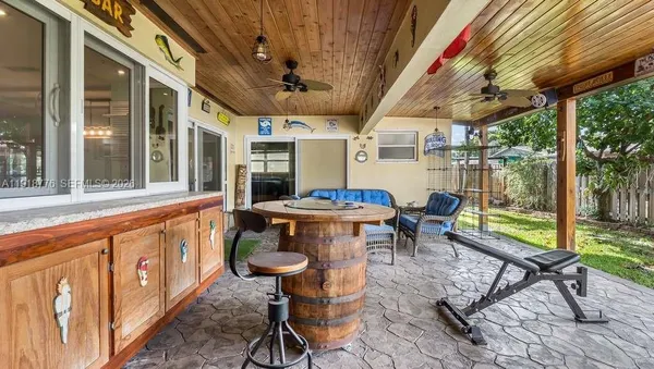 a outdoor space with chairs lots of furniture and wooden floors