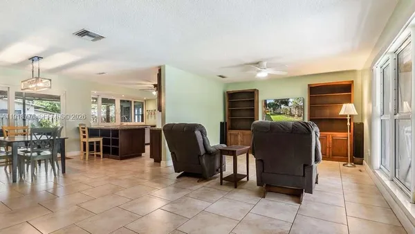 a living room with furniture a dining table and chairs