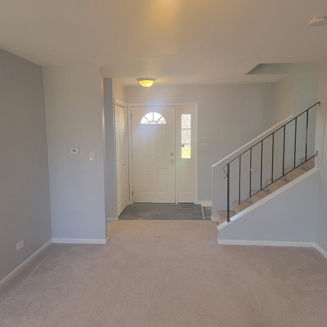217 Pheasant Road Matteson, IL 60443 - Photo 3 of 27 a view of an empty room with stairs and a window