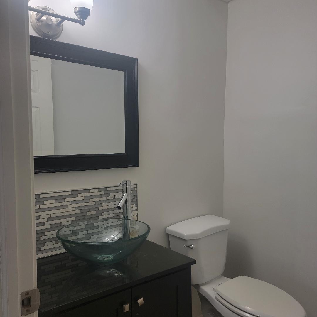 217 Pheasant Road Matteson, IL 60443 - Photo 23 of 27 a bathroom with a toilet a sink and mirror