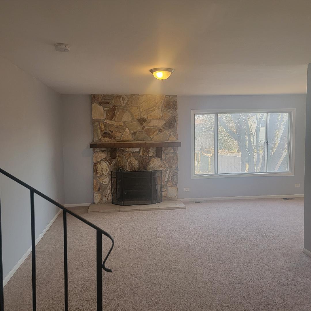 217 Pheasant Road Matteson, IL 60443 - Photo 4 of 27 a view of an empty room with wooden floor and a window