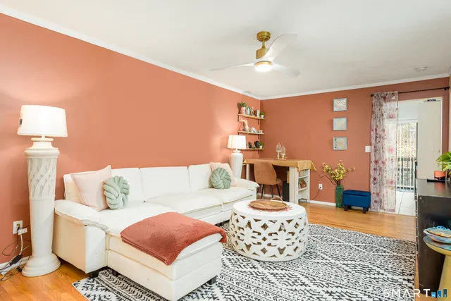 a living room with furniture and a lamp