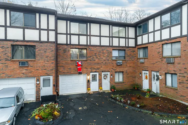 a front view of a house with a yard and outdoor seating
