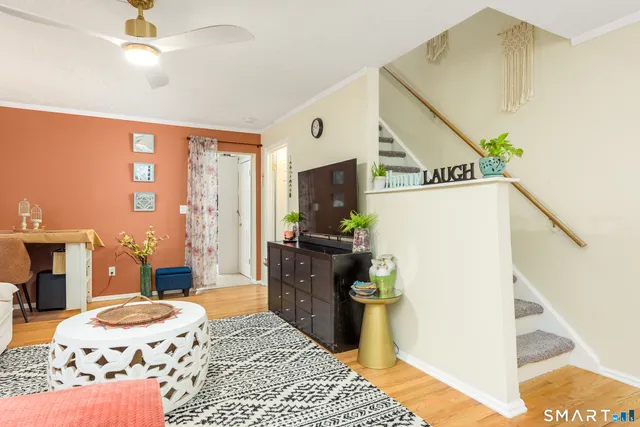 a bedroom with a bed dresser and a flat tv screen