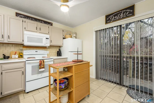 a kitchen with a stove a sink and a refrigerator