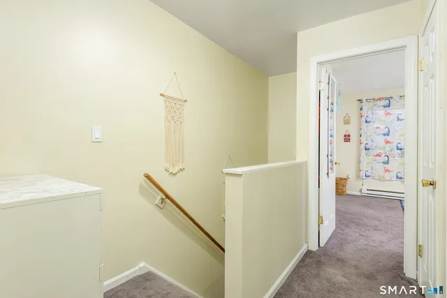 a view of a hallway with bathroom