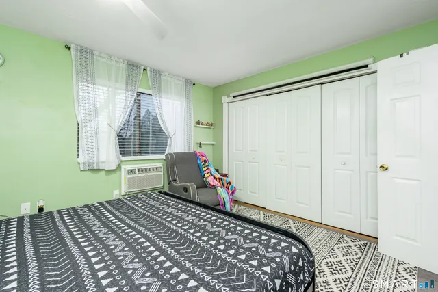 a bedroom with a bed and a window