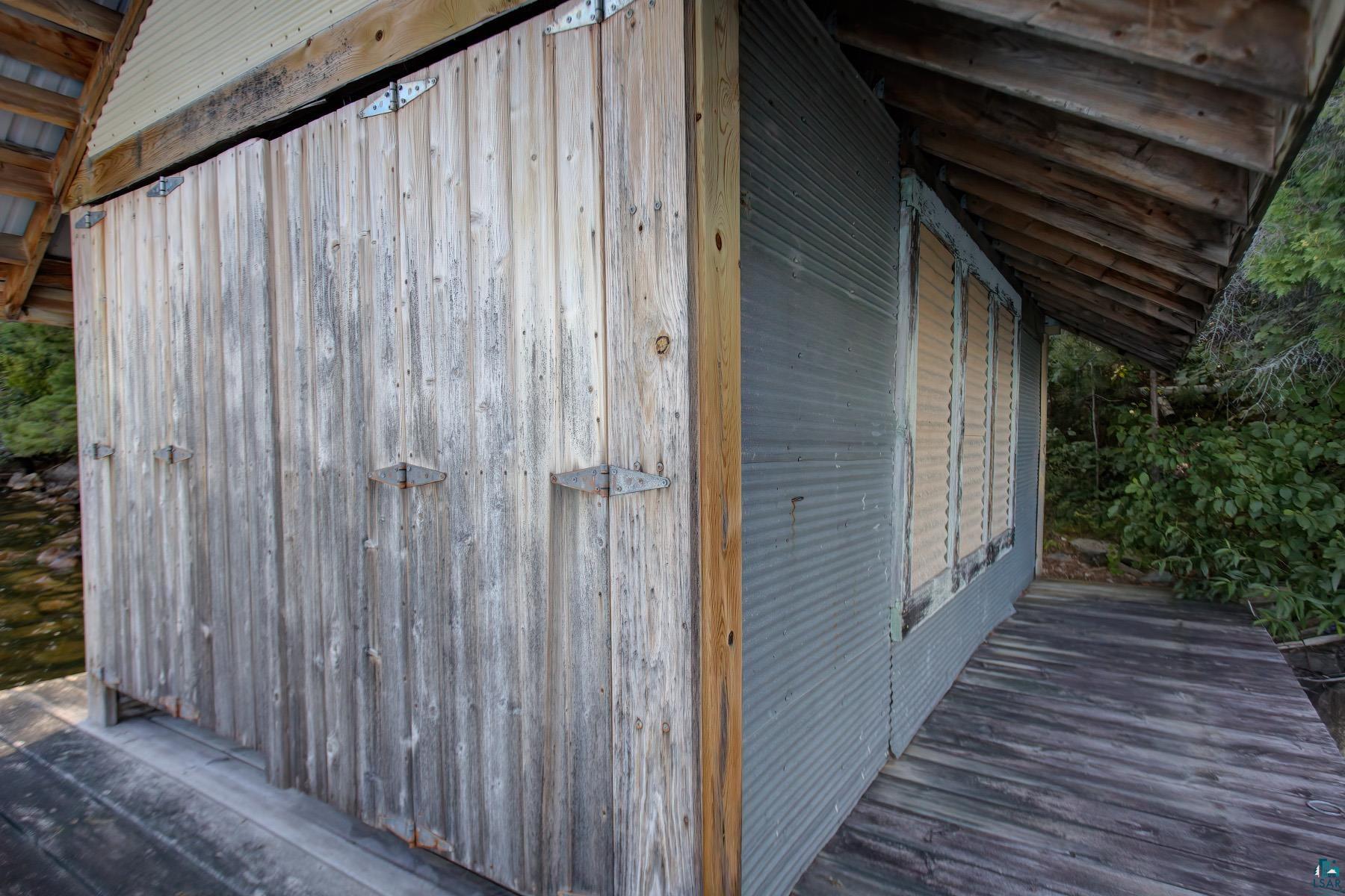 2811 Schaeffer Road Ely, MN 55731 - Photo 10 of 40 Weathered wood plank siding with exposed hinges