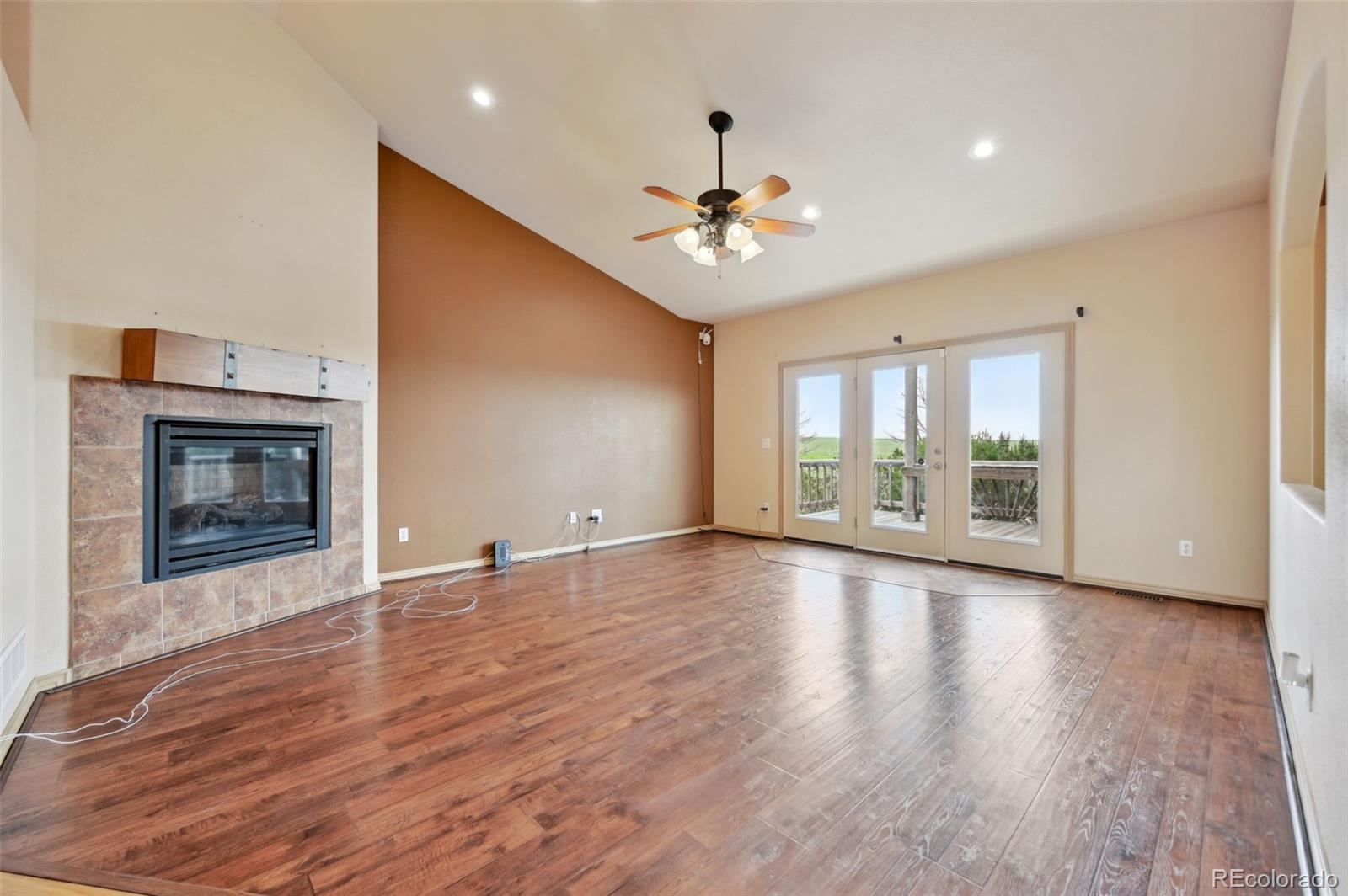 1625 North Yoder Road Yoder, CO 80864 - Photo 11 of 50 a view of an empty room with glass door and a fireplace