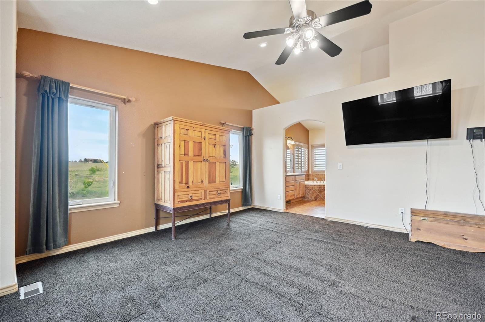 1625 North Yoder Road Yoder, CO 80864 - Photo 18 of 50 a view of an empty room with a window and a flat screen tv