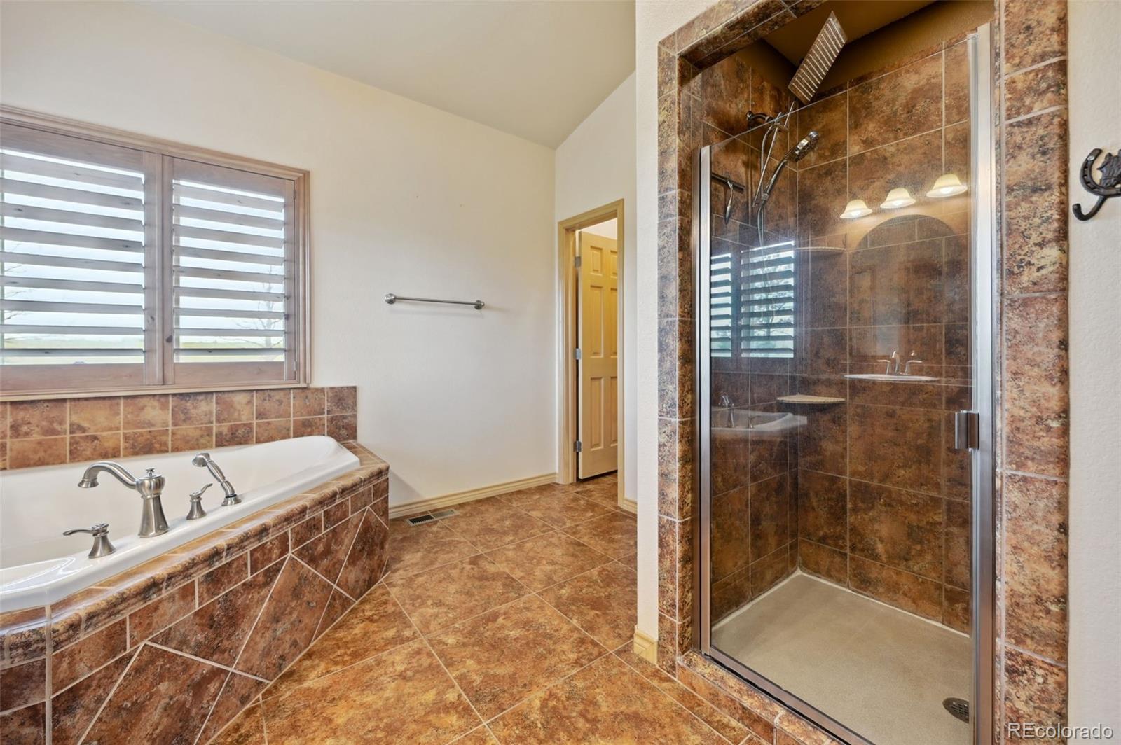 1625 North Yoder Road Yoder, CO 80864 - Photo 20 of 50 a bathroom with a bathtub and a shower