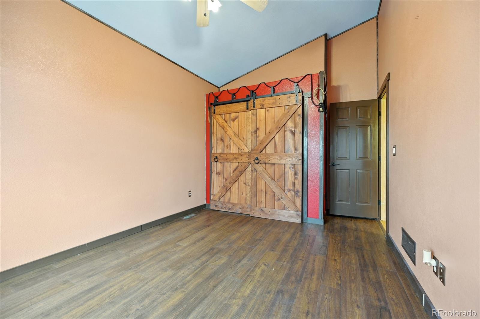 1625 North Yoder Road Yoder, CO 80864 - Photo 26 of 50 an empty room with wooden floor and door
