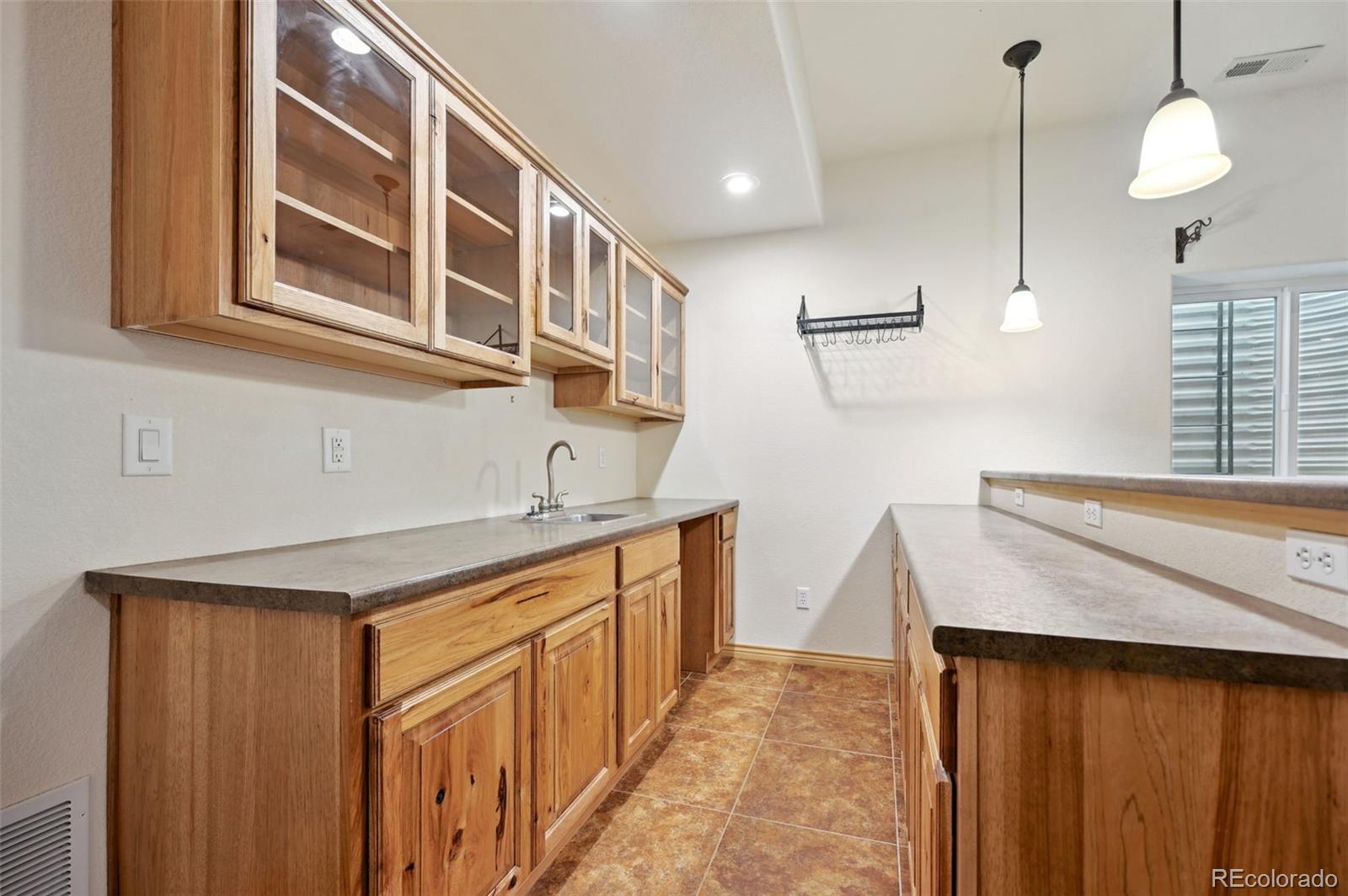1625 North Yoder Road Yoder, CO 80864 - Photo 29 of 50 a kitchen with a sink stove and cabinets